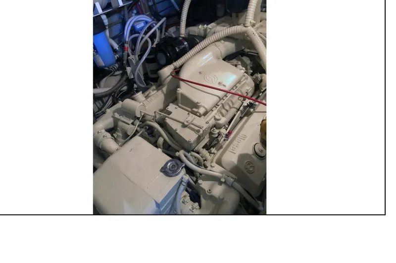 Slide: The Image of Engine room of 1977 Hatteras 58 Yacht Fisherman, showcasing mechanical components. - 17