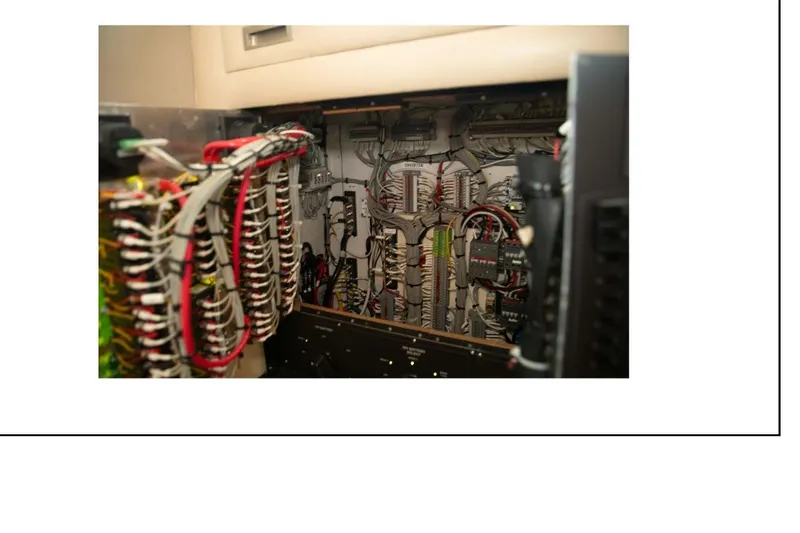 Slide: The Image of Electrical panel of a 1977 Hatteras 58 Yacht Fisherman with complex wiring. - 21
