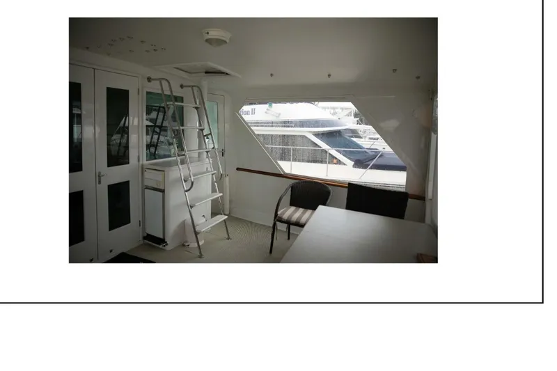 Slide: The Image of Interior of 1977 Hatteras 58 Yacht Fisherman with seating and ladder. - 4