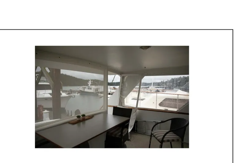Slide: The Image of 1977 Hatteras 58 Yacht Fisherman interior with marina view through windows. - 5