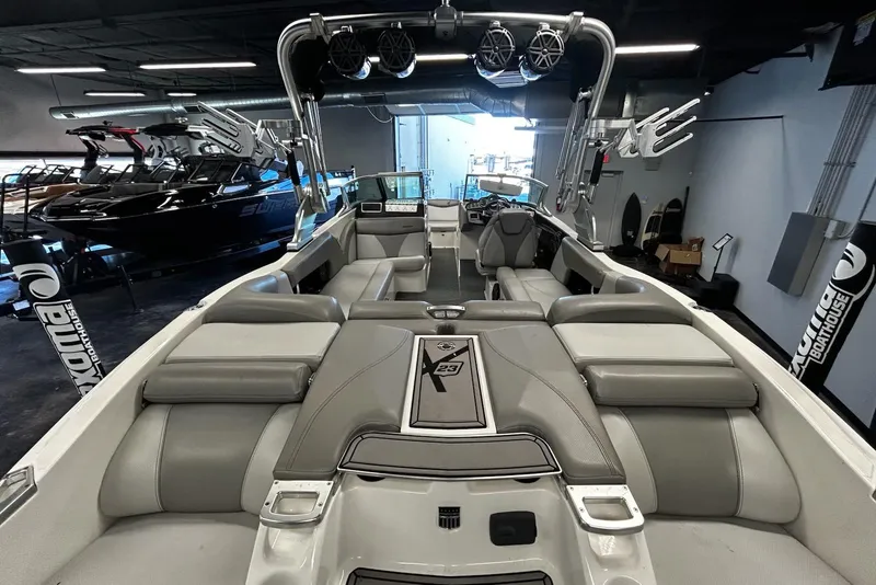 Slide: The Image of 2016 MasterCraft X23 boat interior with gray seating and advanced audio system. - 4