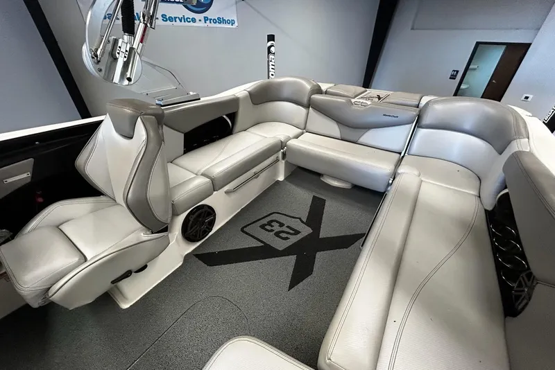 Slide: The Image of 2016 MasterCraft X23 boat interior with gray seating and modern design. - 7
