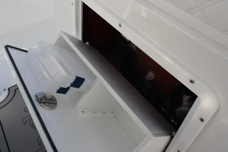 Slide: The Image of Storage compartment in 2026 BlackJack 256 Coastal boat, featuring organized interior space. - 16