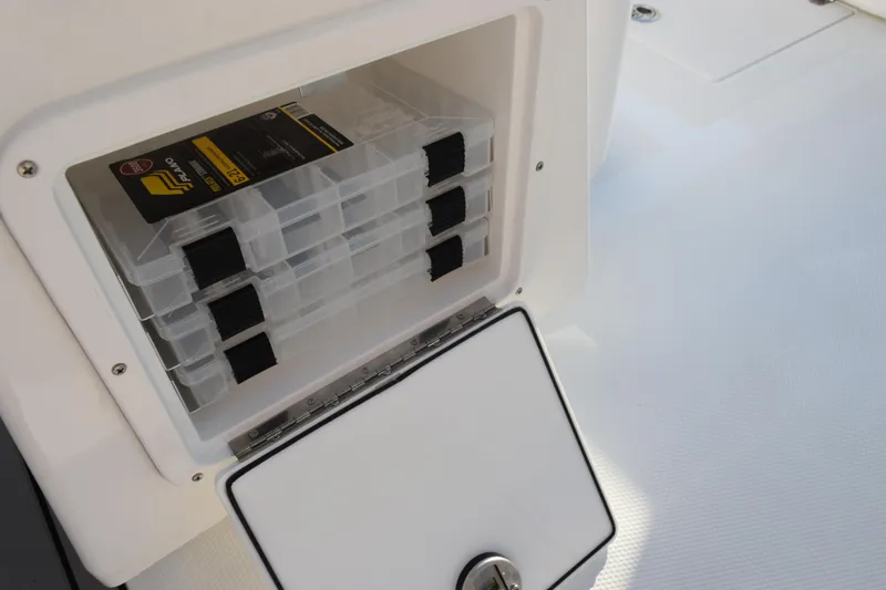 Slide: The Image of Storage compartment with tackle boxes on a 2026 BlackJack 256 Coastal boat. - 17