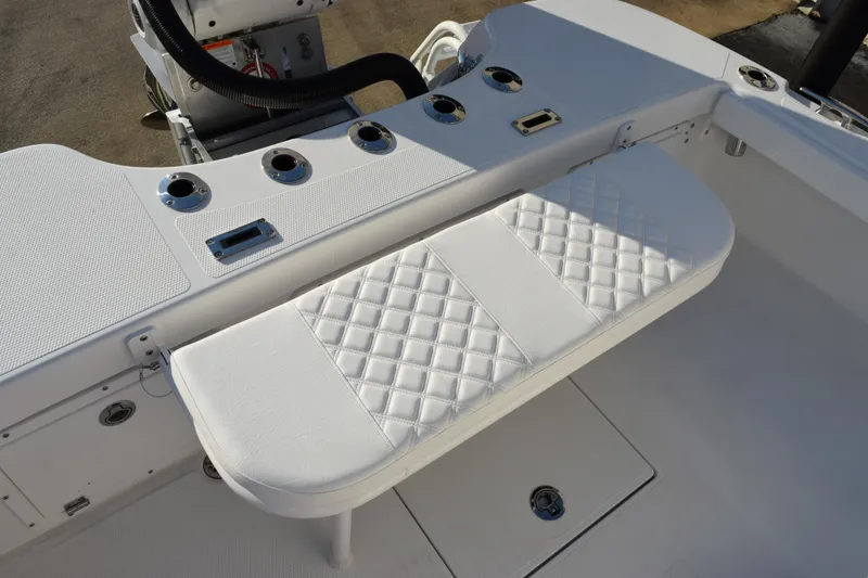 Slide: The Image of 2026 BlackJack 256 Coastal boat interior with white cushioned seating and rod holders. - 19