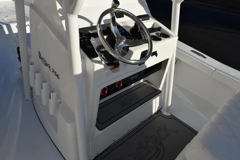 Slide: The Image of 2026 BlackJack 256 Coastal boat interior with steering wheel and control panel. - 8