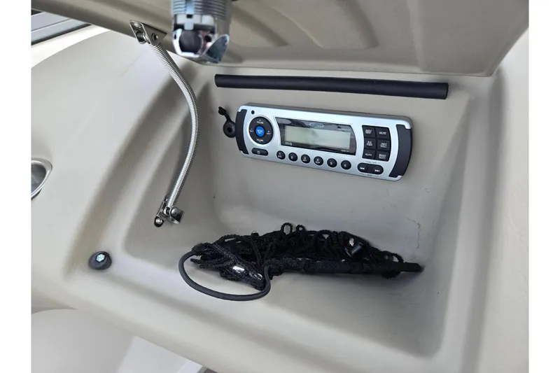 Slide: The Image of Boat dashboard with stereo system in 2011 Larson LX 850 model. - 13