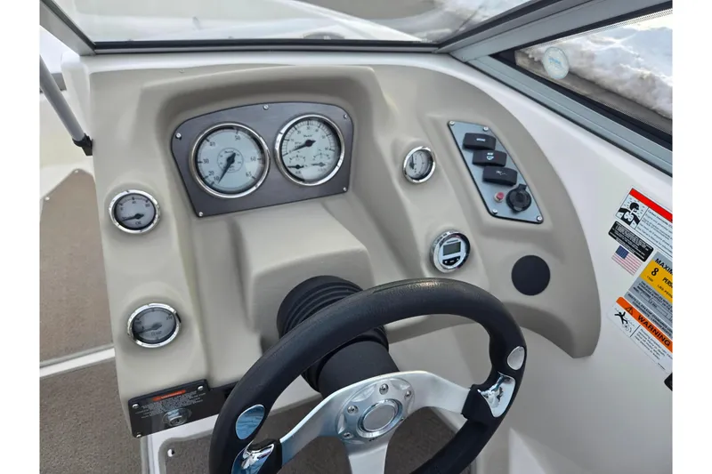 Slide: The Image of 2011 Larson LX 850 boat dashboard with gauges and steering wheel. - 14