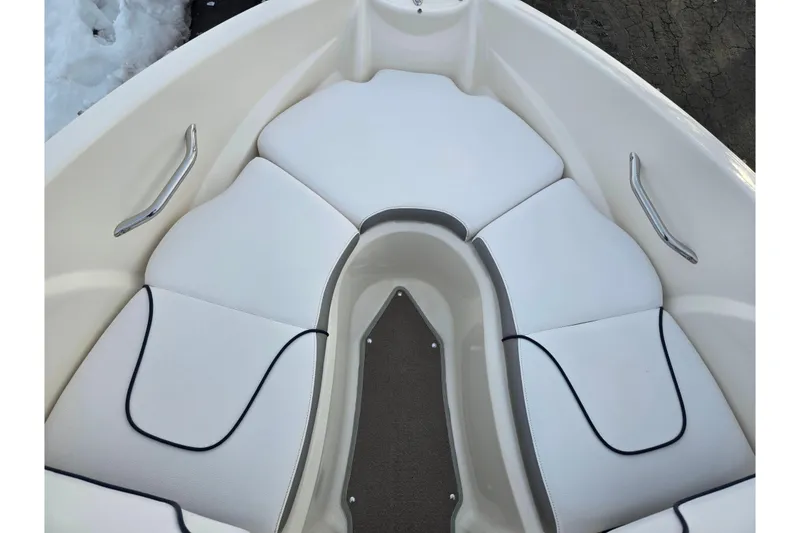 Slide: The Image of Bow seating area of 2011 Larson LX 850 boat with white cushions and metal handles. - 16