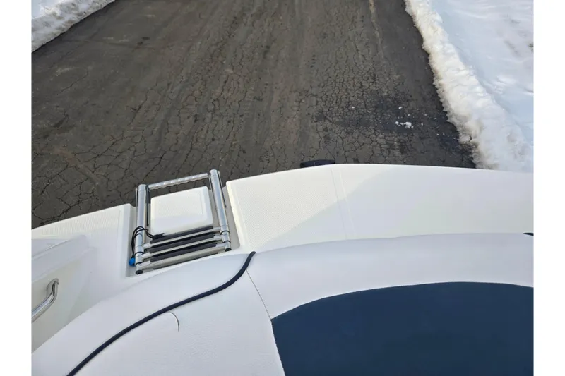 Slide: The Image of Larson LX 850 boat rear view with ladder, snowy road background, 2011 model. - 22