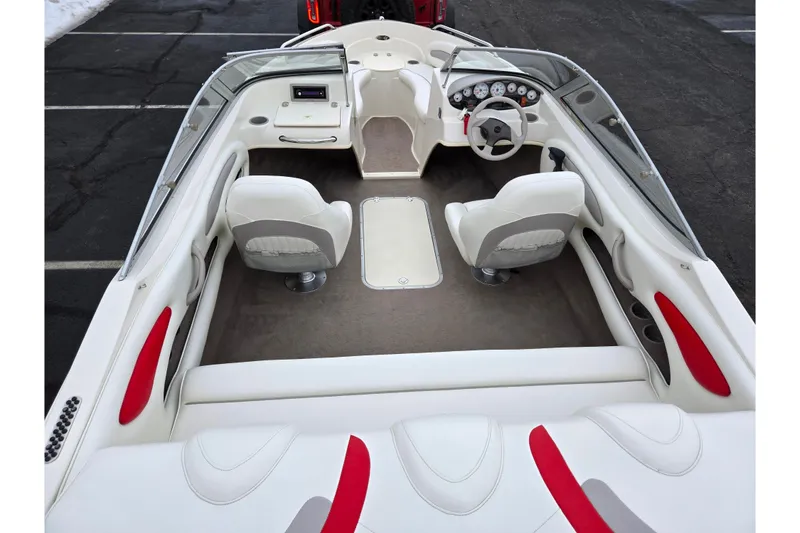 Slide: The Image of 2008 Stingray 195 LS/LX/LR boat interior with white and red seating, steering wheel, and dashboard. - 10