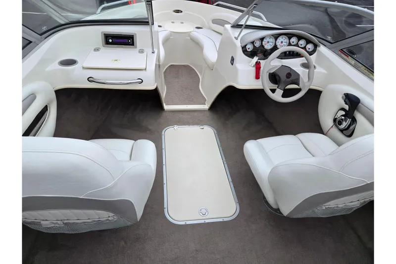 Slide: The Image of 2008 Stingray 195 LS/LX/LR boat interior with white seating and modern dashboard. - 11