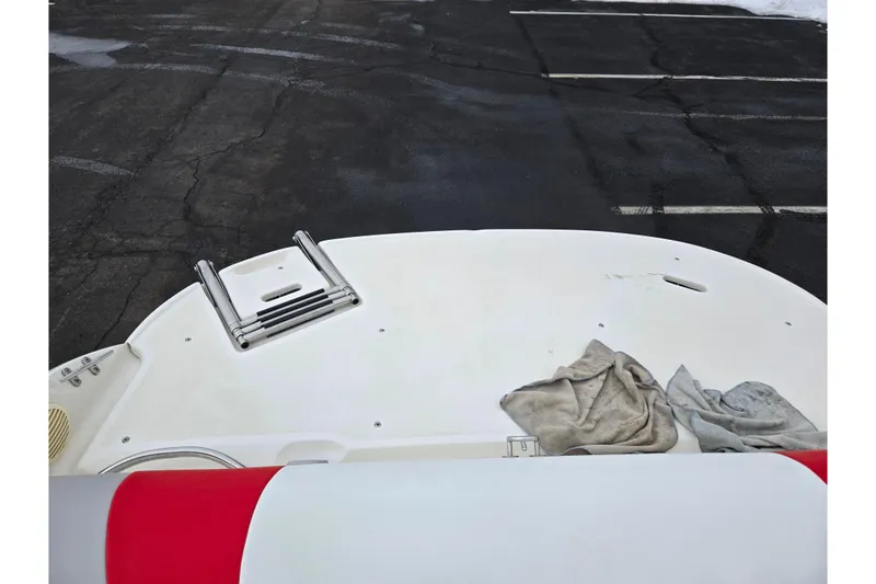 Slide: The Image of 2008 Stingray 195 LS/LX/LR boat with swim platform and ladder, parked on asphalt. - 23