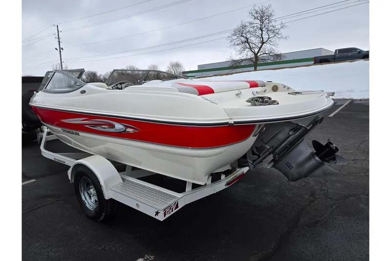 Slide: The Image of 2008 Stingray 195 LS/LX/LR boat on trailer, red and white design, parked outdoors. - 3