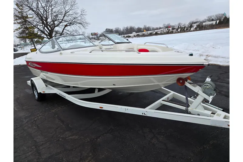 Slide: The Image of 2008 Stingray 195 LS/LX/LR boat on trailer, red and white design, parked on snowy pavement. - 8