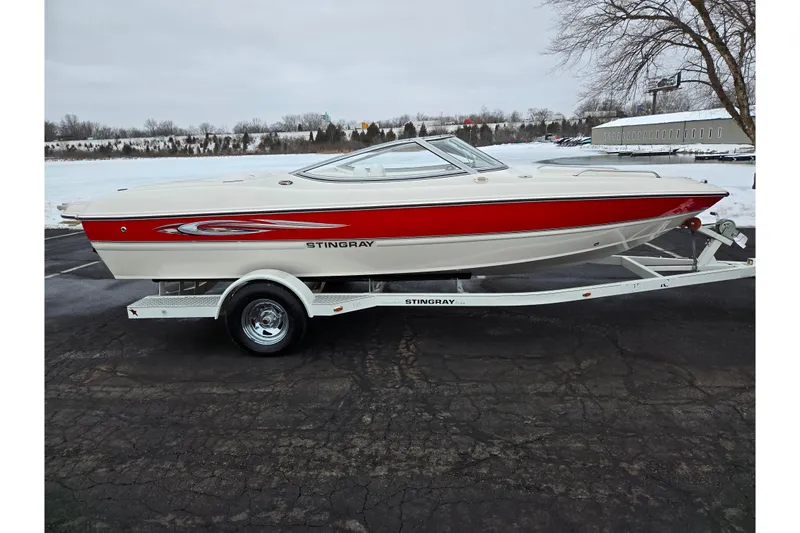 Slide: The Image of 2008 Stingray 195 LS/LX/LR boat on trailer, red and white design, parked outdoors. - 9