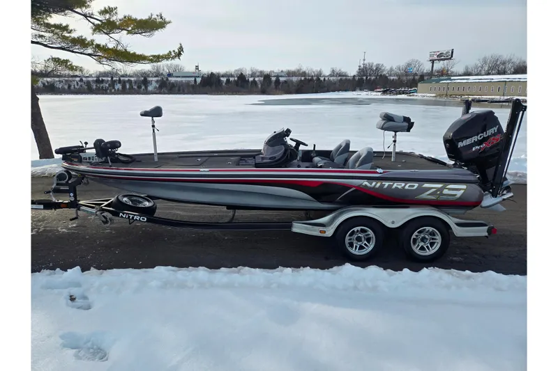 Slide: The Image of 2013 Nitro Z-9 boat on trailer by snowy lake, featuring Mercury Pro XS engine. - 10