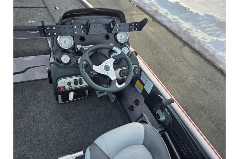 Slide: The Image of 2013 Nitro Z-9 boat cockpit with steering wheel and gauges, parked on snowy pavement. - 12