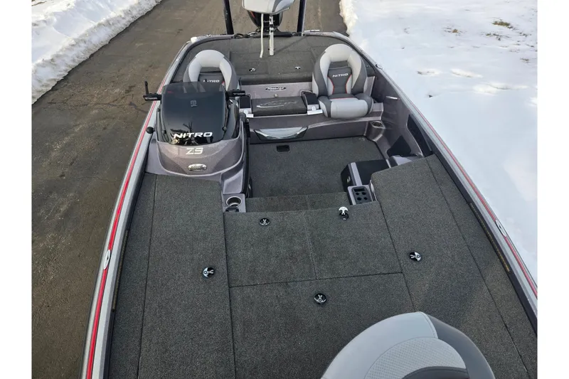 Slide: The Image of 2013 Nitro Z-9 boat interior with seating and storage, parked on snowy roadside. - 18