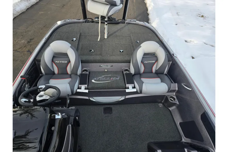 Slide: The Image of 2013 Nitro Z-9 boat interior with dual seats and steering wheel, parked on snowy pavement. - 19