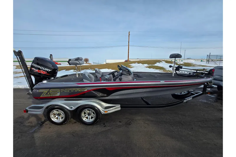 Slide: The Image of 2013 Nitro Z-9 boat with Mercury Pro XS engine on trailer, parked on snowy pavement. - 4