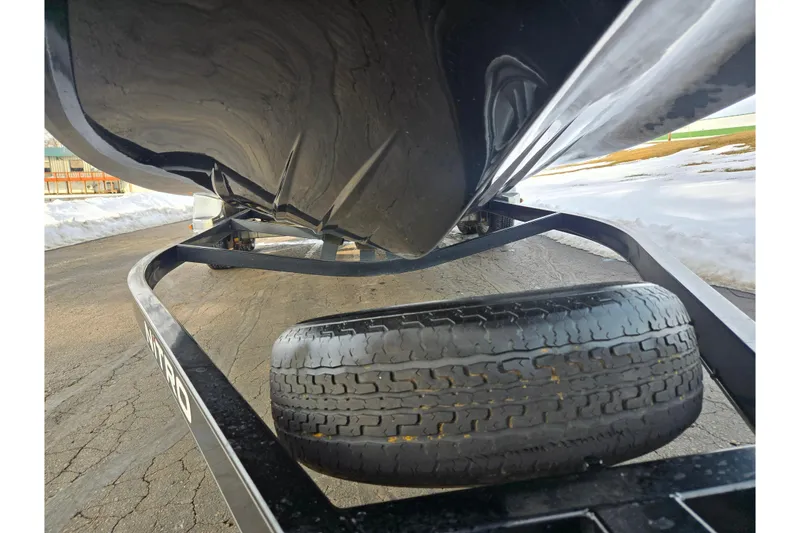 Slide: The Image of 2013 Nitro Z-9 boat trailer with visible tire and snow in the background. - 7