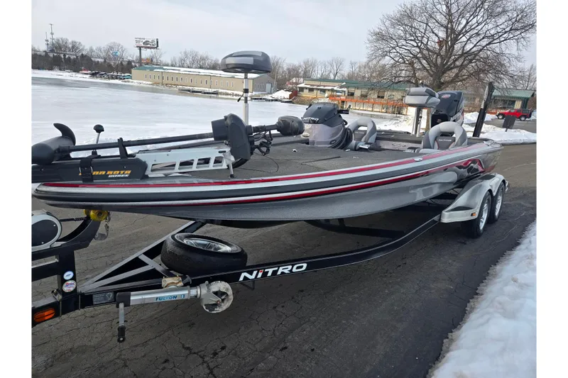 Slide: The Image of 2013 Nitro Z-9 boat on trailer, parked near snowy lake, winter setting. - 9