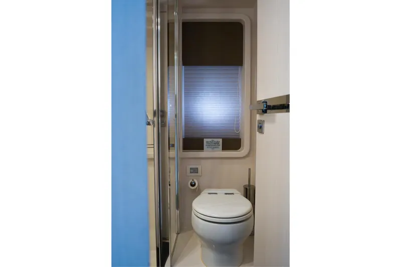 Slide: The Image of Bathroom interior of 2019 Azimut Fly 50 yacht, featuring modern toilet and window. - 22