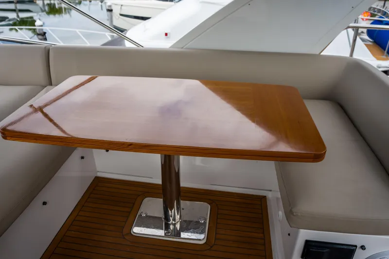 Slide: The Image of Luxurious 2019 Azimut Fly 50 yacht with elegant wooden table and cushioned seating. - 36