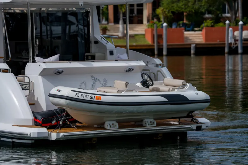 Slide: The Image of 2019 Azimut Fly 50 yacht with a small tender boat on the water. - 42