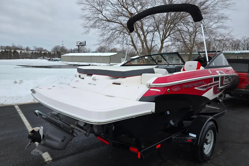 Slide: The Image of 2017 Regal 1900 ESX Bowrider boat on trailer in snowy parking lot. - 1
