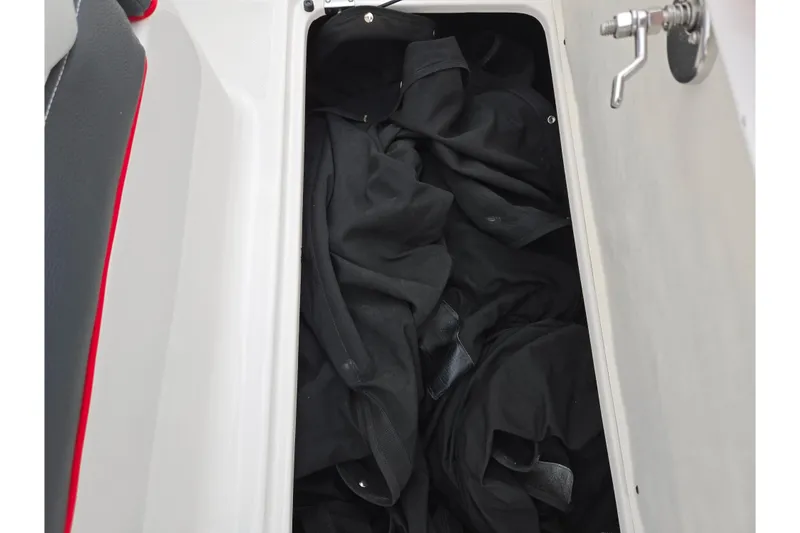 Slide: The Image of Storage compartment in 2017 Regal 1900 ESX Bowrider with black fabric inside. - 12