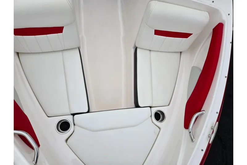 Slide: The Image of 2017 Regal 1900 ESX Bowrider interior with white and red seating, cup holders, and handles. - 18