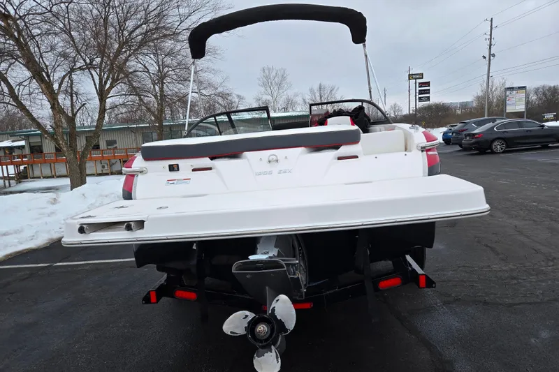 Slide: The Image of 2017 Regal 1900 ESX Bowrider boat on trailer in snowy parking lot. - 2