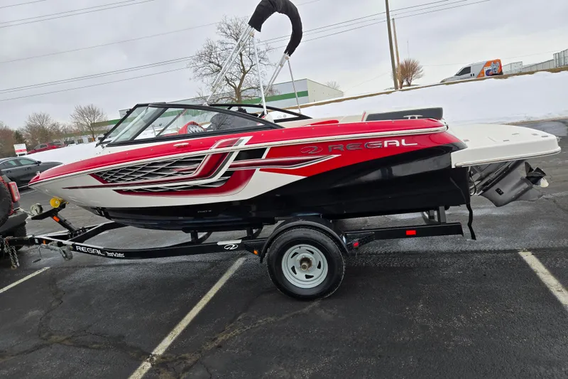 Slide: The Image of 2017 Regal 1900 ESX Bowrider boat on trailer in parking lot. - 4