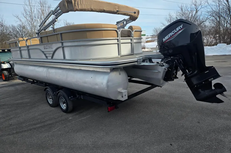 Slide: The Image of 2021 Lowe SS 230 WT pontoon boat with Mercury outboard motor on trailer. - 1