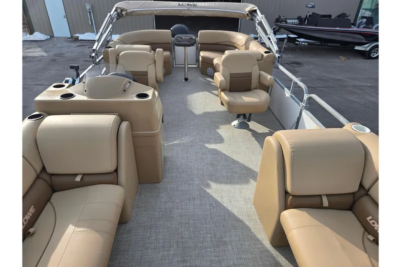Slide: The Image of 2021 Lowe SS 230 WT pontoon boat with beige seating and spacious deck layout. - 12
