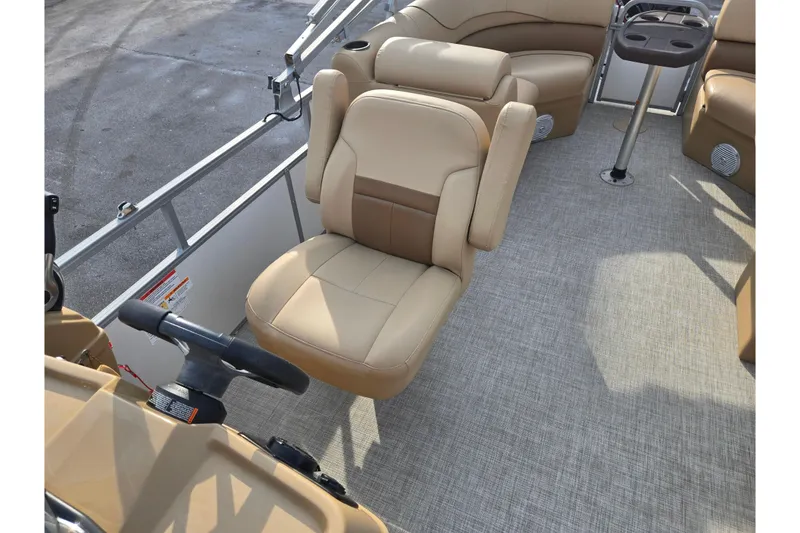 Slide: The Image of 2021 Lowe SS 230 WT boat interior with beige seating and steering wheel. - 14
