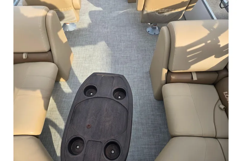 Slide: The Image of Interior of 2021 Lowe SS 230 WT boat with beige seating and central table. - 18