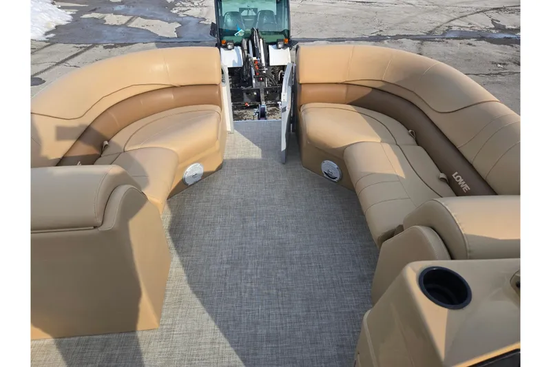 Slide: The Image of 2021 Lowe SS 230 WT pontoon boat with tan seating and spacious deck. - 21