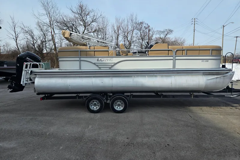 Slide: The Image of 2021 Lowe SS 230 WT pontoon boat on trailer, parked outdoors. - 4