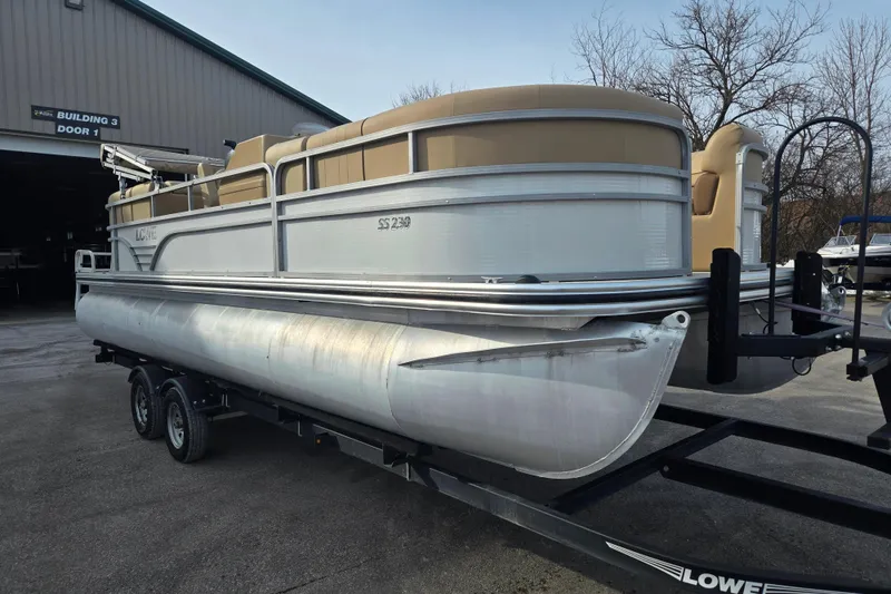 Slide: The Image of 2021 Lowe SS 230 WT pontoon boat on trailer outside building. - 5