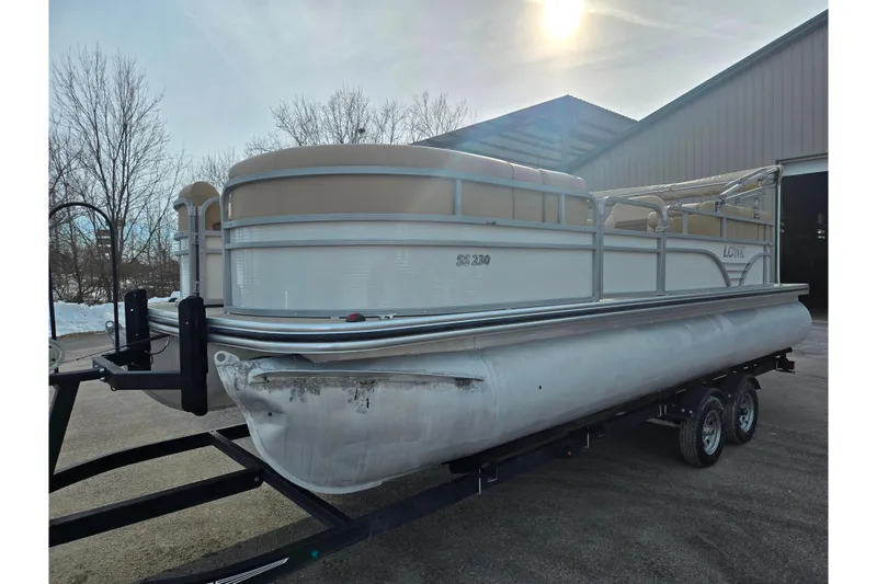 Slide: The Image of 2021 Lowe SS 230 WT pontoon boat on trailer, parked outdoors. - 9