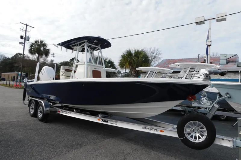 The Image of 2026 Pathfinder 2600 TRS boat on trailer, parked outdoors, showcasing sleek design. - 0