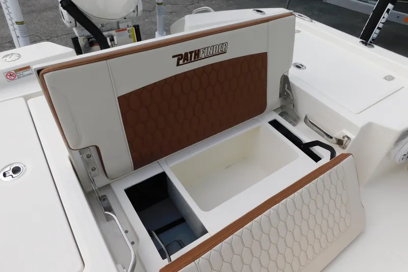 Slide: The Image of 2026 Pathfinder 2600 TRS boat seat with storage compartment, featuring brown and white upholstery. - 10