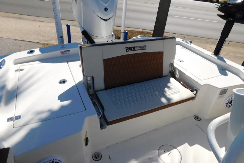 Slide: The Image of 2026 Pathfinder 2600 TRS boat interior with cushioned seating and storage compartments. - 23