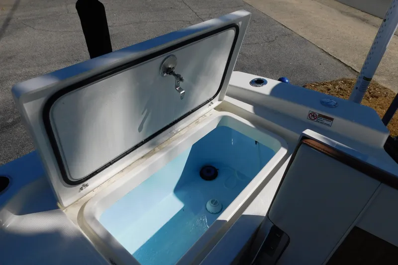 Slide: The Image of Livewell on 2026 Pathfinder 2600 TRS boat, open lid, blue interior. - 24