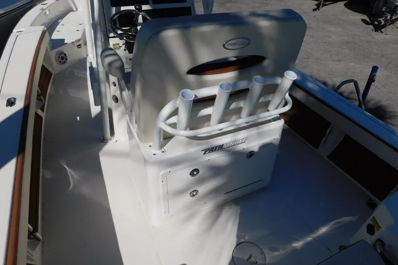 Slide: The Image of 2026 Pathfinder 2600 TRS boat interior with rod holders and steering console. - 26