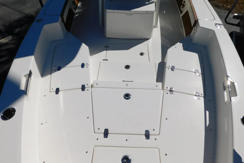 Slide: The Image of 2026 Pathfinder 2600 TRS boat deck with storage compartments and seating area. - 29