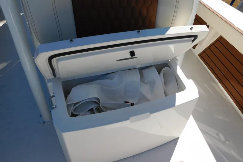 Slide: The Image of Open storage compartment on 2026 Pathfinder 2600 TRS boat with white fabric inside. - 31